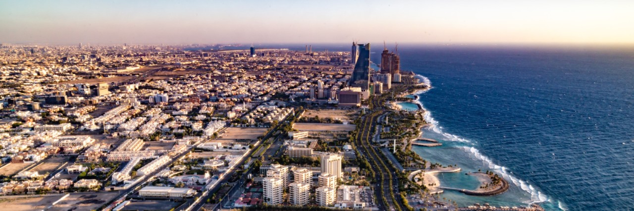 Aerial view of the city of Jeddah, situated on the coast, flat buildings with few structural high points near the water. © sainuddeen/stock.adobe.com  