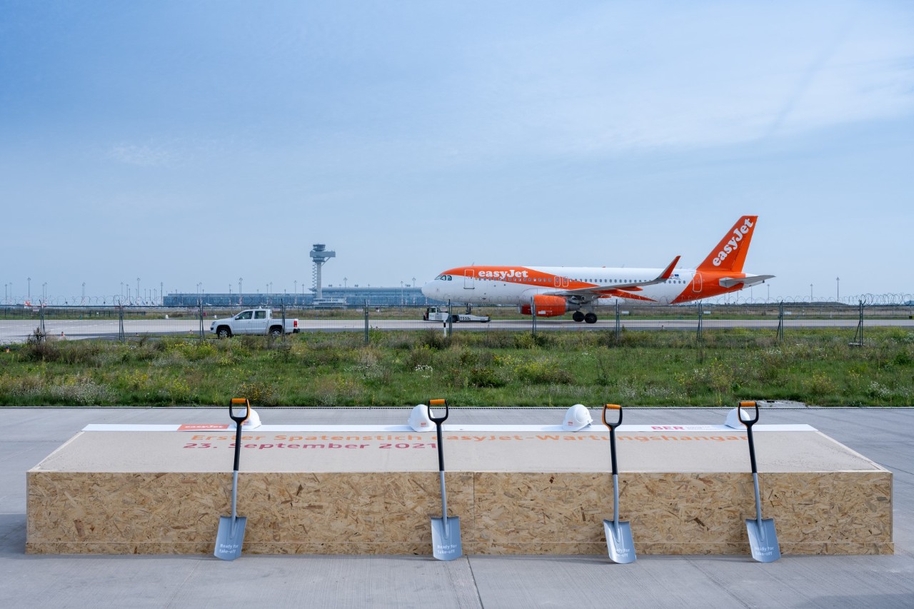 Four shovels in the foreground, EasyJet aircraft in the background