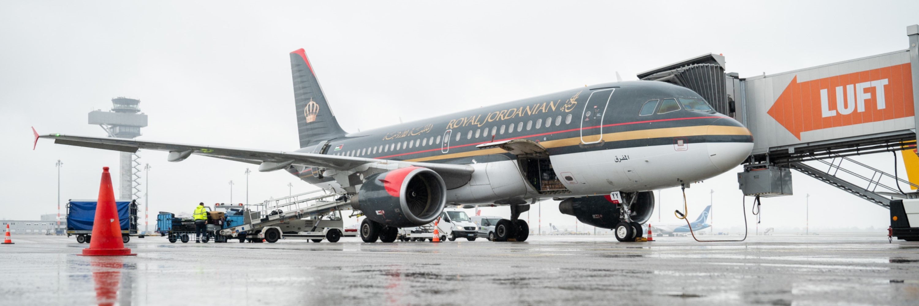 Royal Jordan Air aircraft on the apron.  Behind the tower.