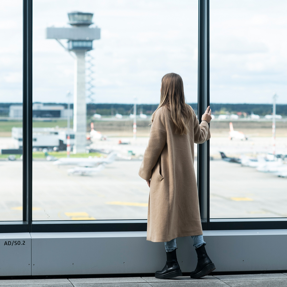 Frau auf der Besucherterrasse schaut aufs Vorfeld