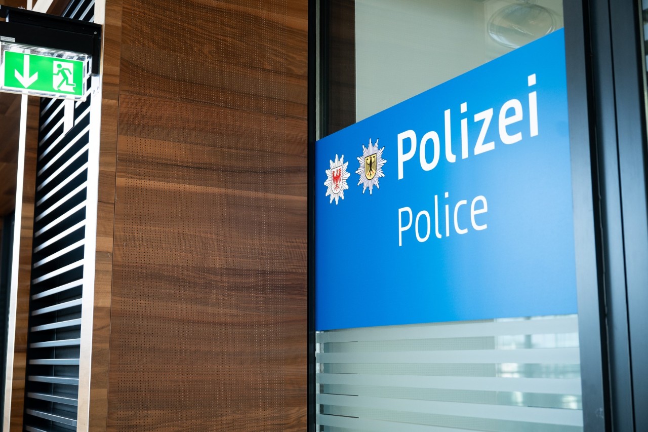 Detailaufnahme des Eingangsbereichs mit den Wappen der Landespolizei Brandenburg und der Bundespolizei sowie dem Aufdruck Polizei.