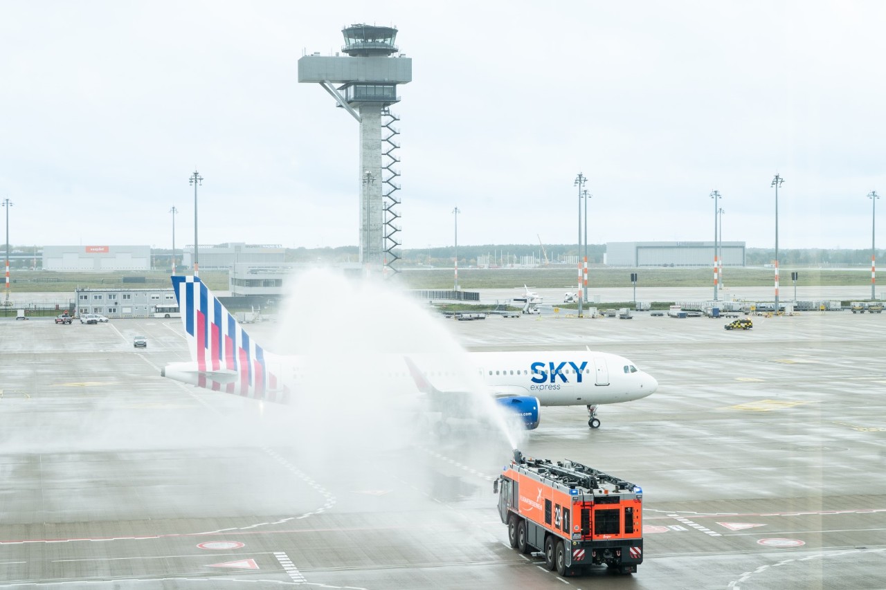 Ein Flugzeug von Sky Express wird von der Flughafenfeuerwehr am BER mit einer Wasserfontäne begrüßt.