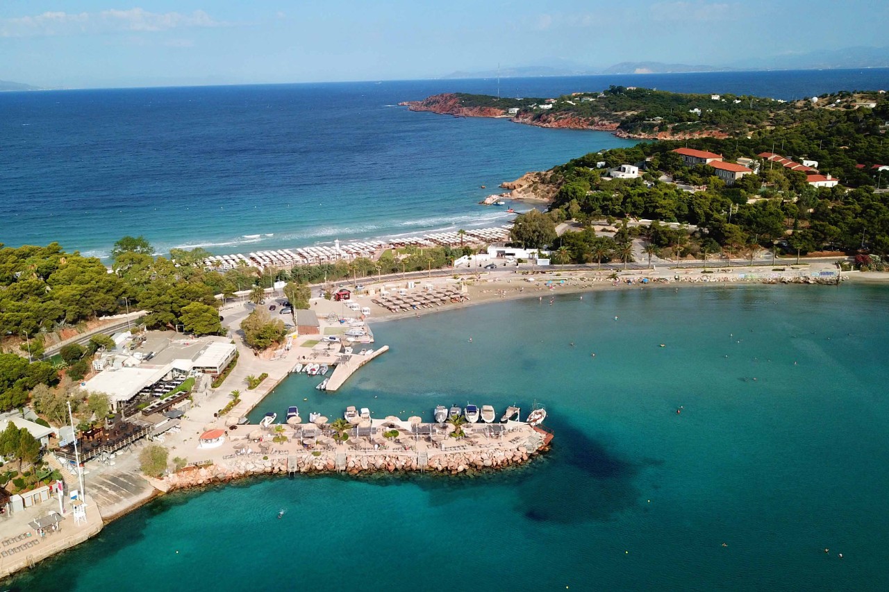 Asteras Strand in Glyfada mit klarem Wasser und Sonnenschirmen.