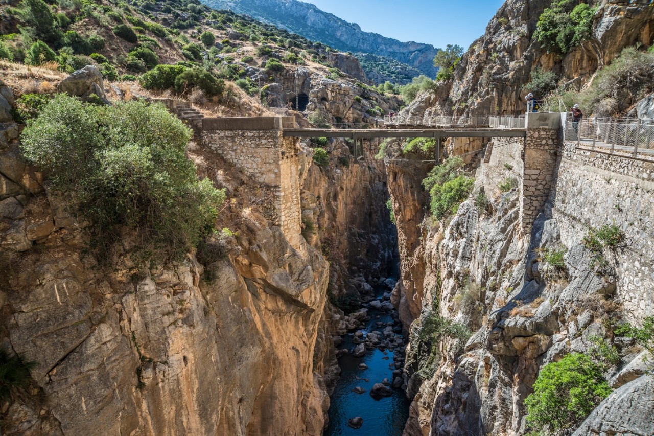 Schmaler Wanderweg am Fels entlang über einer tiefen Schlucht im Caminito del Rey.