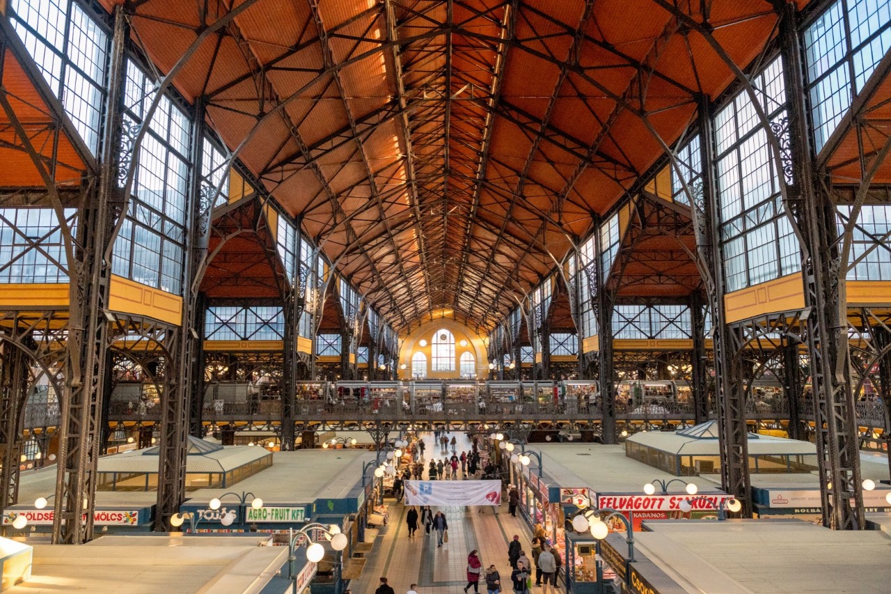 Innenansicht der Markthalle mit Ständen und Besuchern.