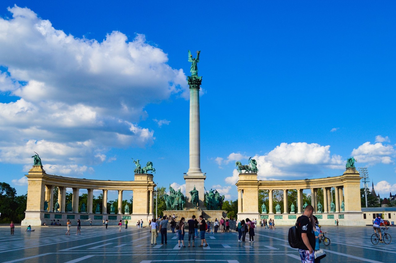Heldenplatz in Budapest mit Statuen und hoher Säule.