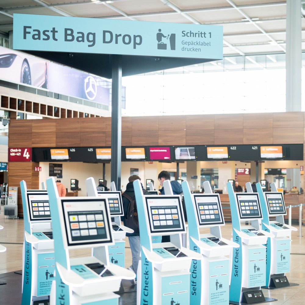 Fast Bag drop Automaten im Terminal 1. Großes Schild mit dem Schriftzug Fast Bag drop darüber.