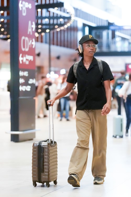 Person mit einem Koffer am Flughafen.