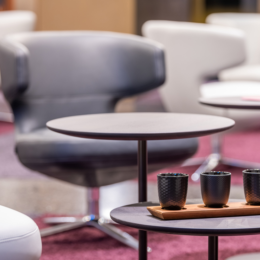 Seating area with armchairs and tables.