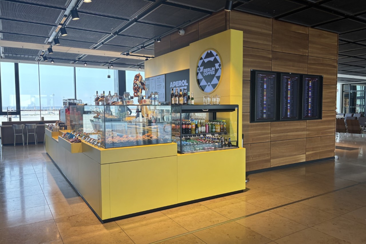 A Coffee Bar in yellow and black inside an Airport building
