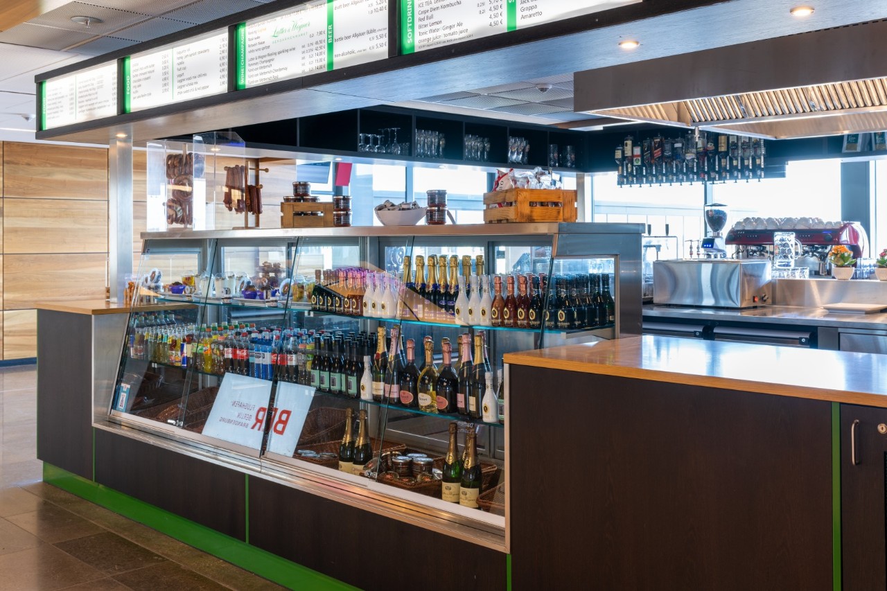 Counter with bottles in the display case.