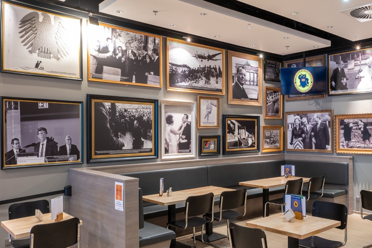 Wall in the Ständige Vertretung with pictures of personalities.