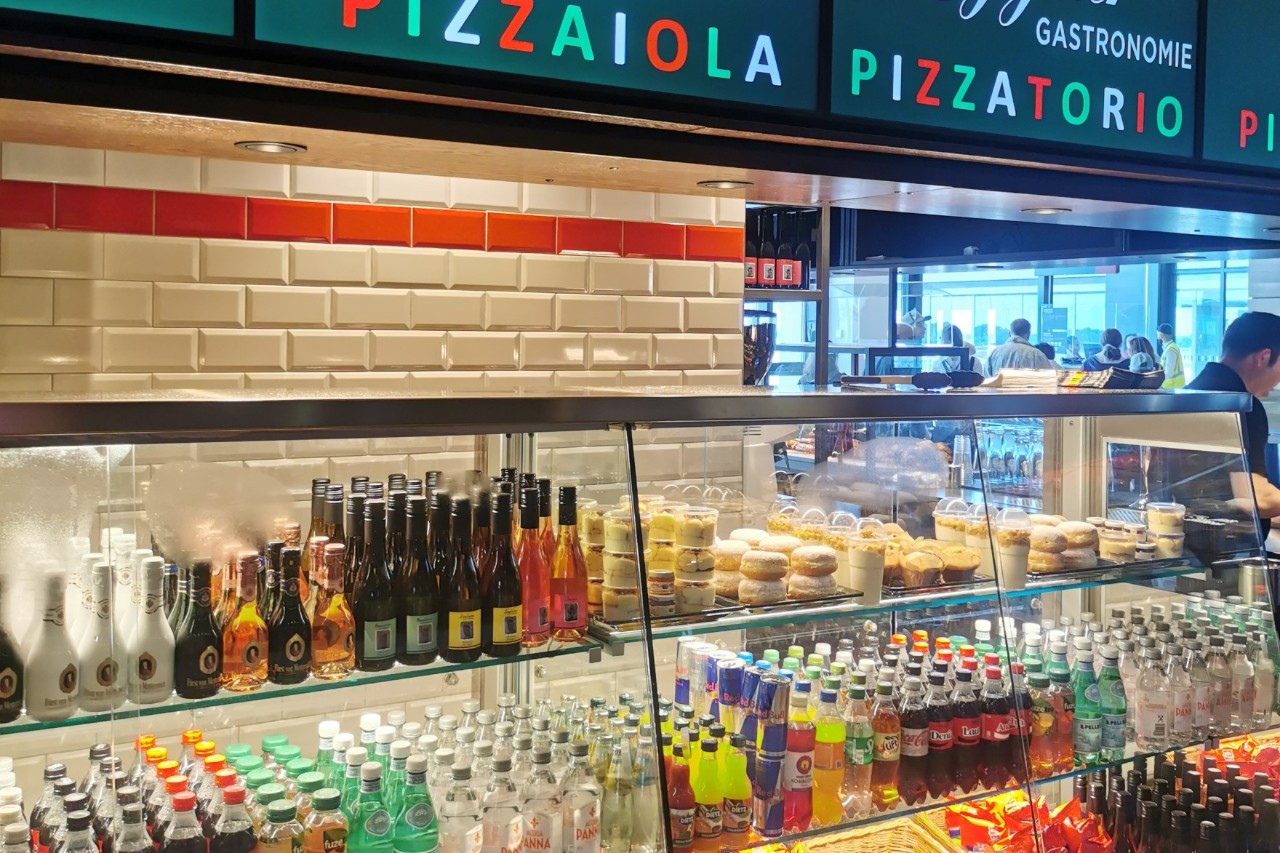 Counter with bottles in the display case.