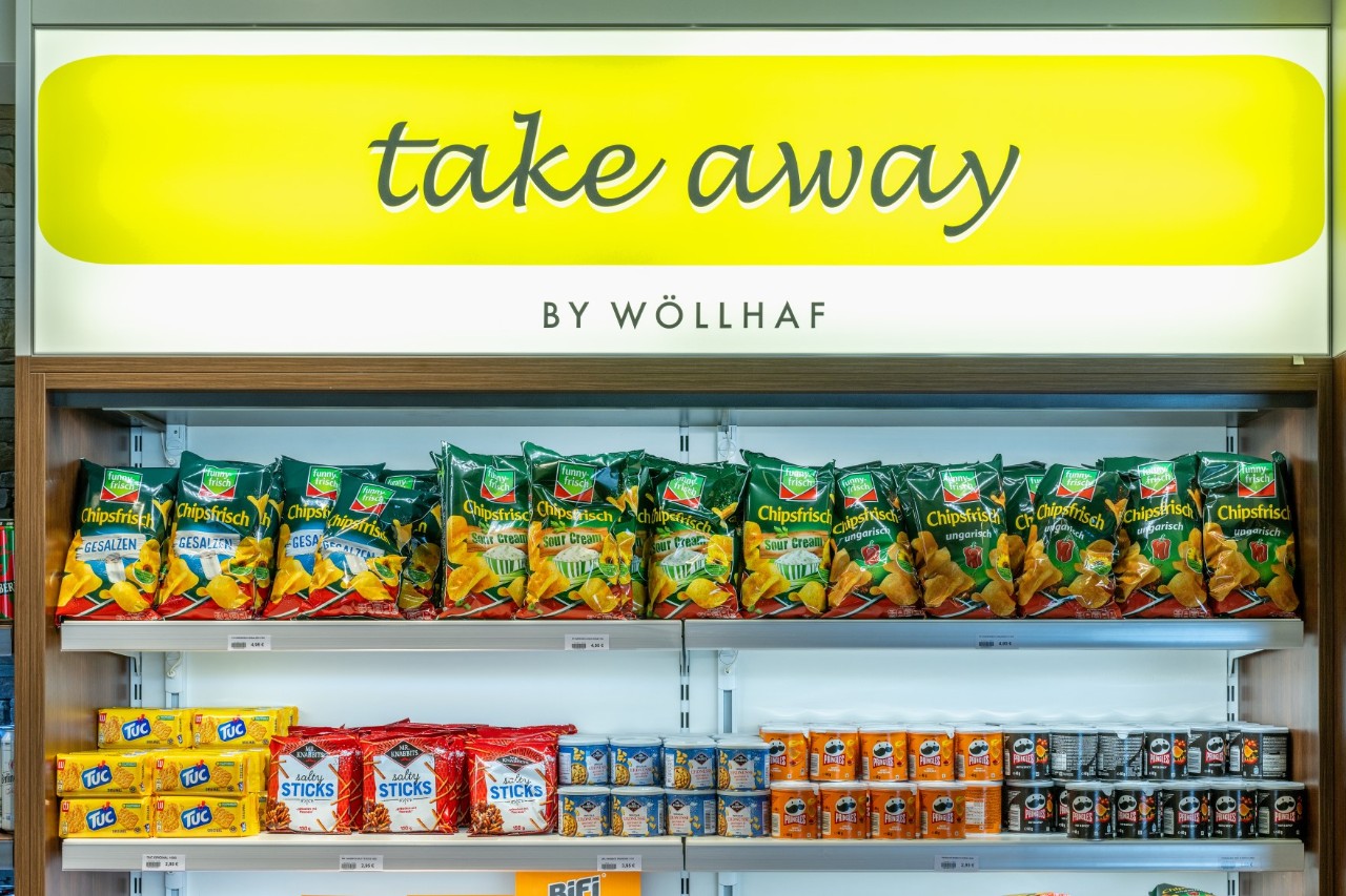 Close-up of the take-away shop display. Crisps, biscuits and peanuts.
