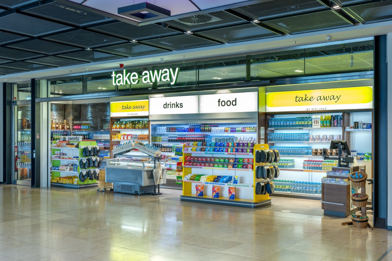 View of the take-away store from outside. Postcards, travel accessories and toys on display.