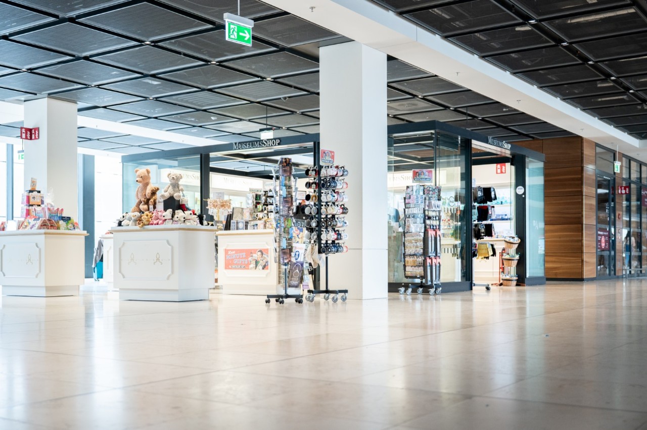 View of the museum shop from outside. Souvenirs are displayed in front of the shop.