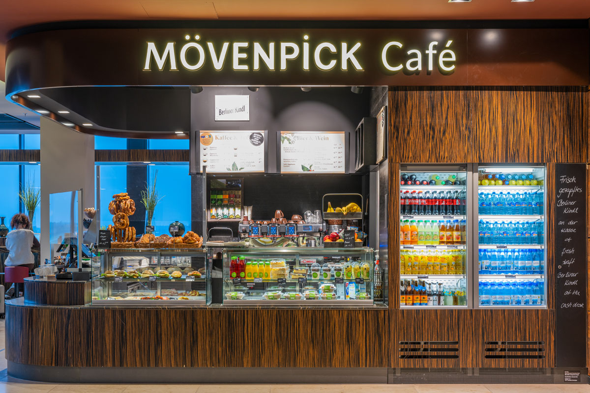 View from the outside of the counter with drinks and food on offer.