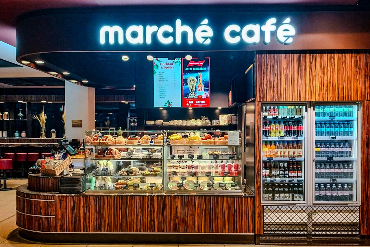 View from the outside of the counter with drinks and food on offer.