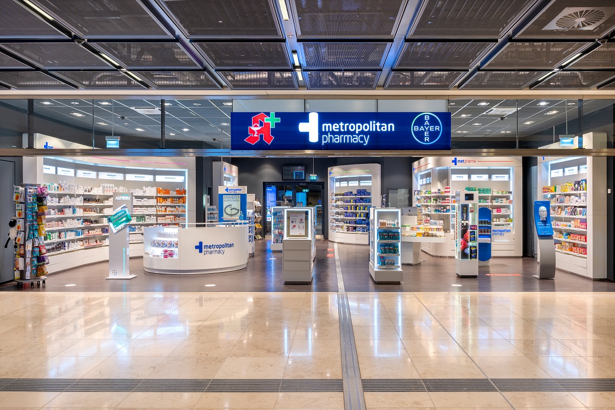 View from outside into the pharmacy with counter and wall shelves.