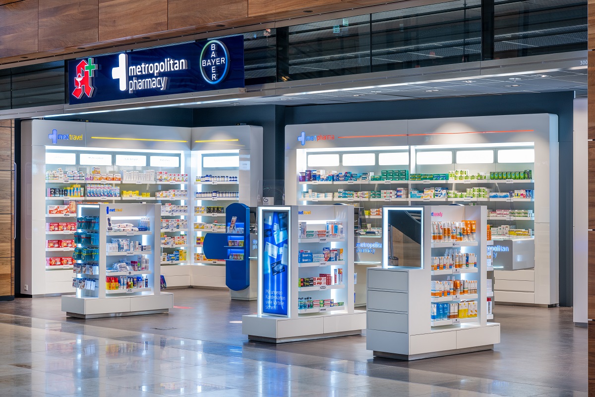 View from outside into the pharmacy with counter and wall shelves.