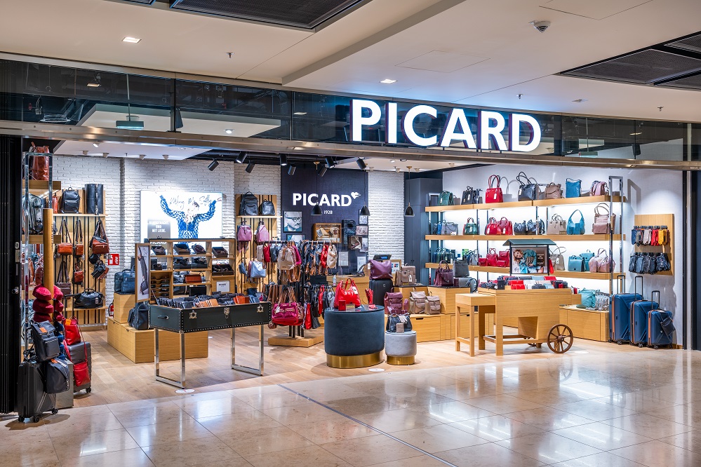 View of the store from outside. Suitcases and leather goods on display.