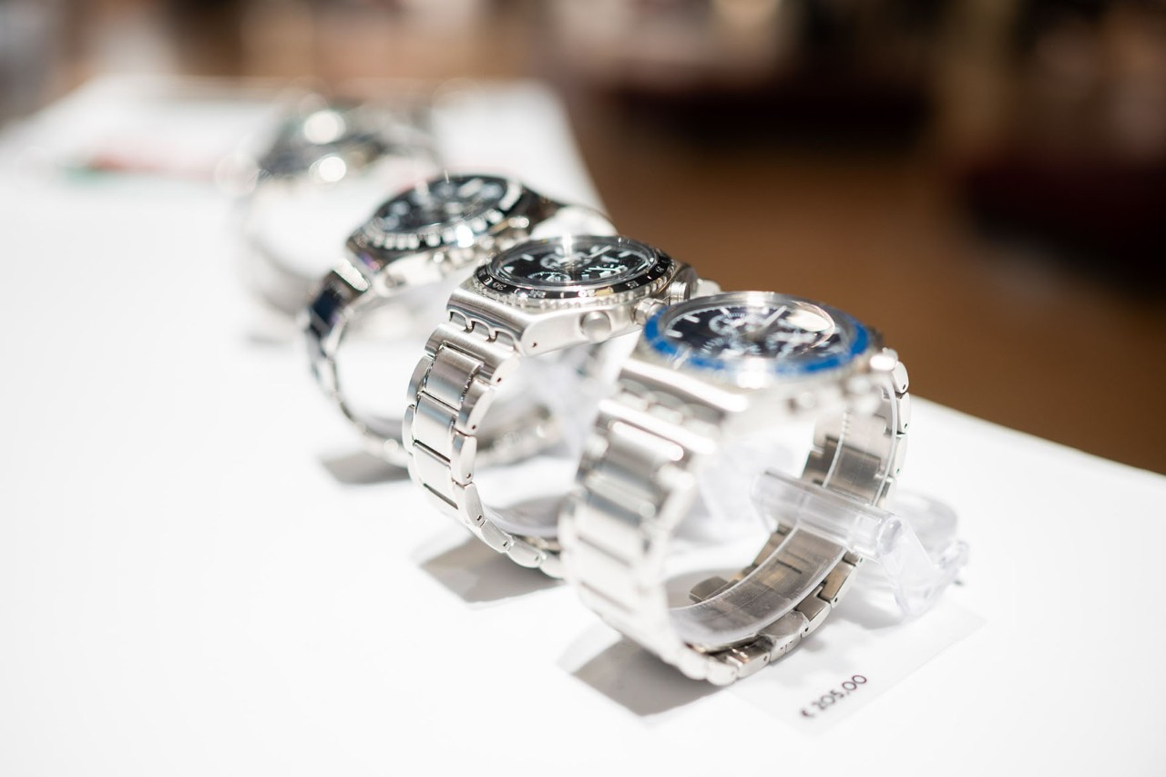Three silver watches on display