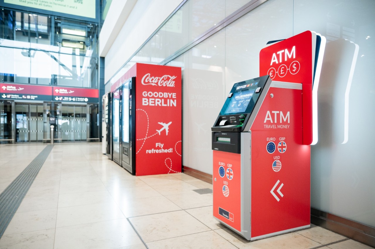 ATM in the foreground. Behind it a lift.