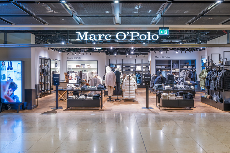 View from outside into the Marc O Polo store. Counter with clothing.