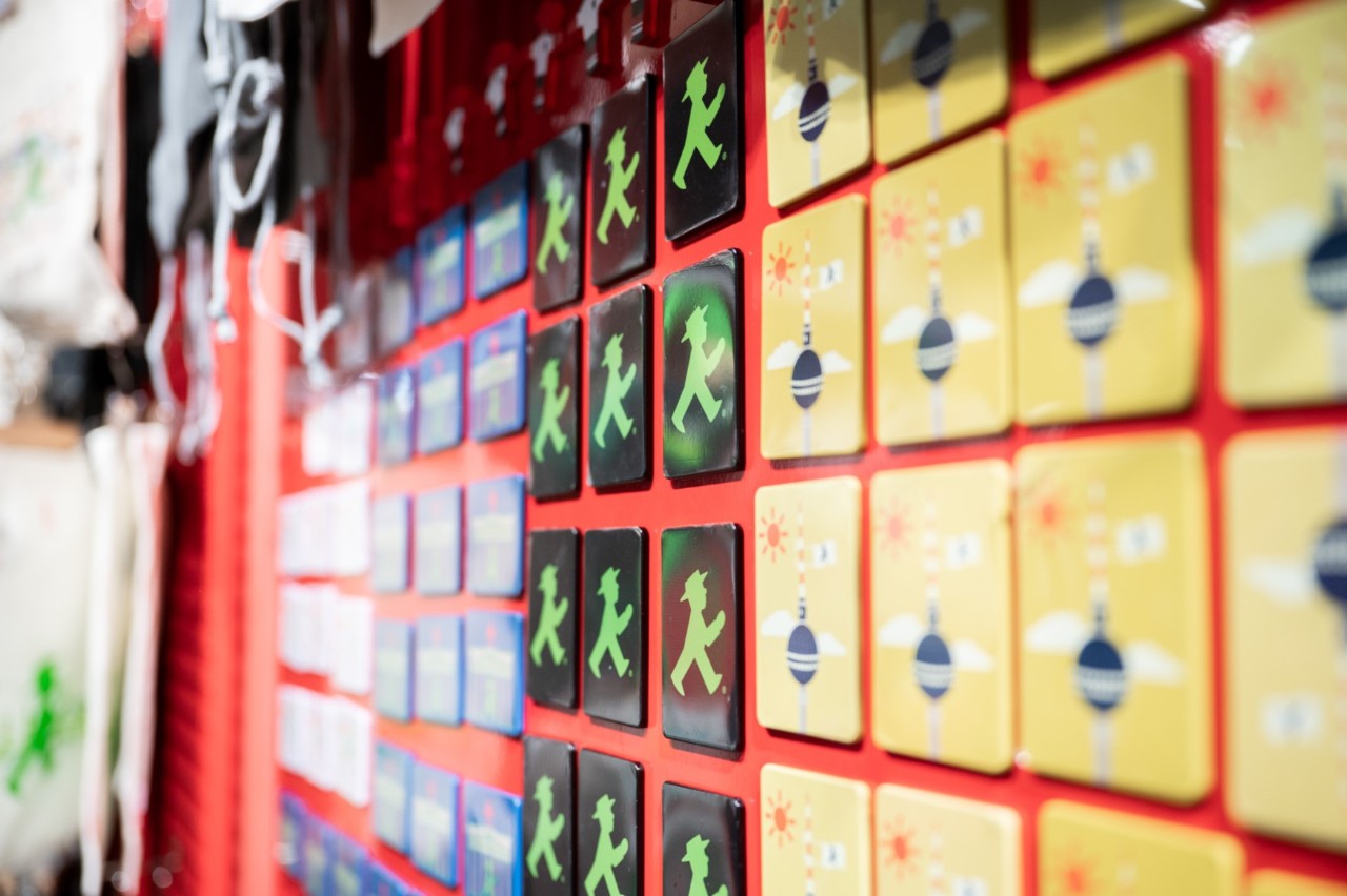 Details of a wall with Ampelmann and TV tower magnets.