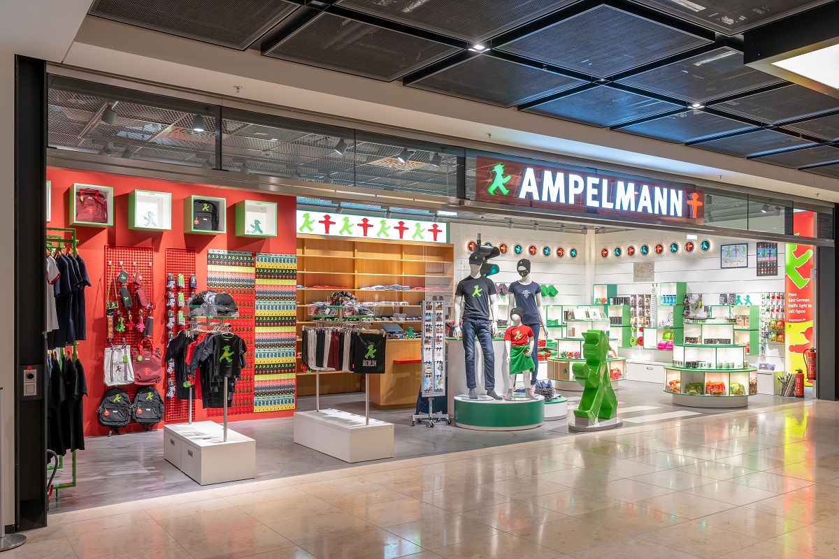 View of the Ampelmann store from outside. Clothing on counters and wall shelves.