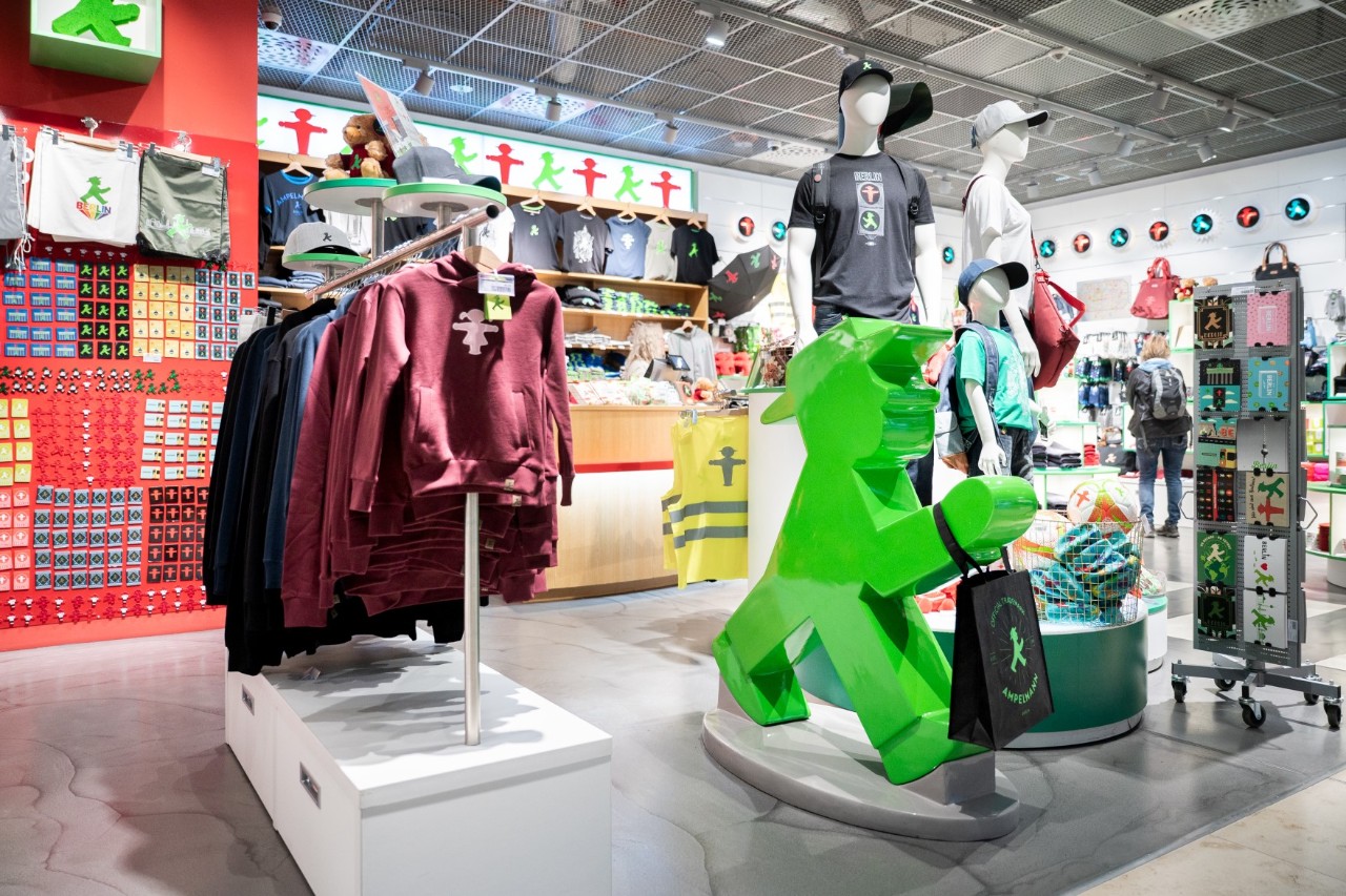 Interior view of the AMPELMANN store at Berlin Brandenburg Airport featuring a selection of souvenirs and accessories themed around the iconic East German pedestrian traffic light figures.