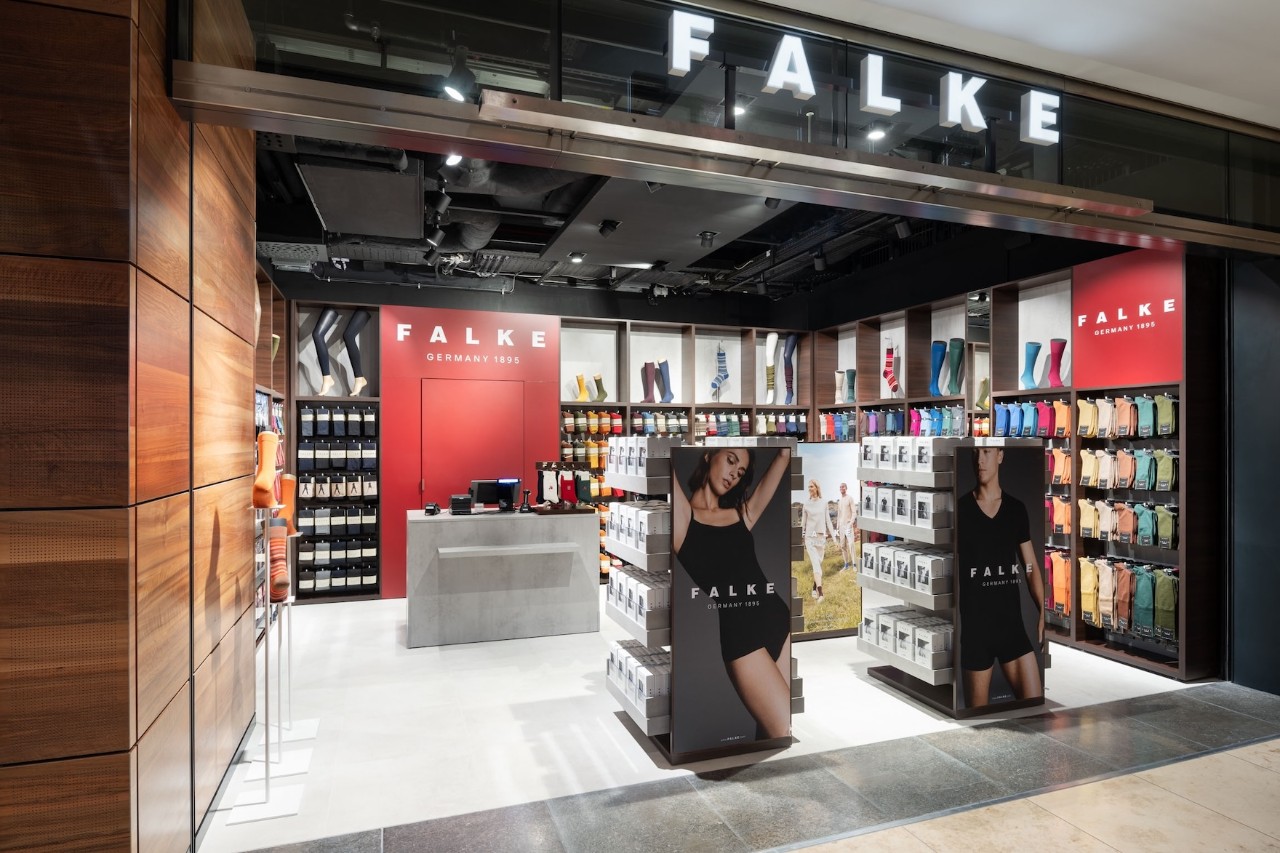 View of the Falke store from outside. Hosiery on display and wall shelves.