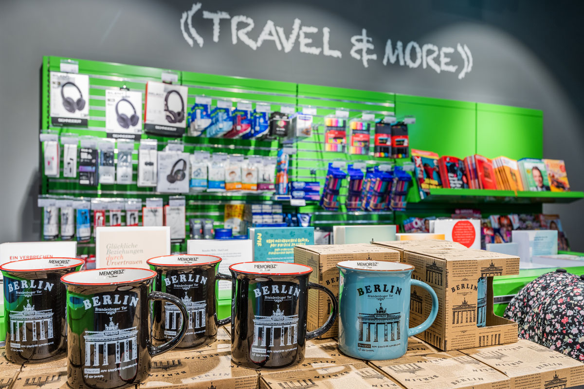 View of a counter with coffee cups and headphones on the wall.