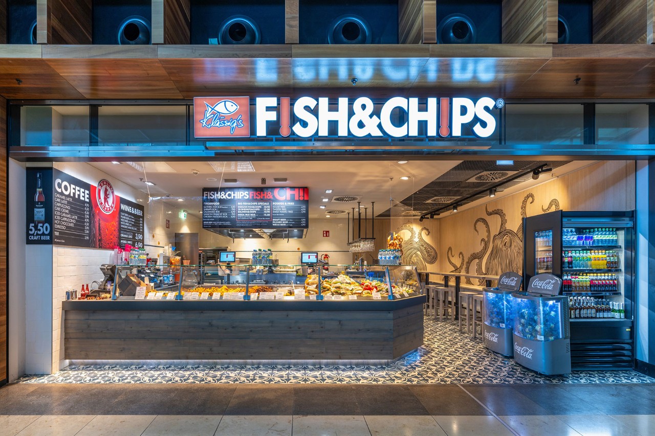 View of the counter with food. Seating in the background.