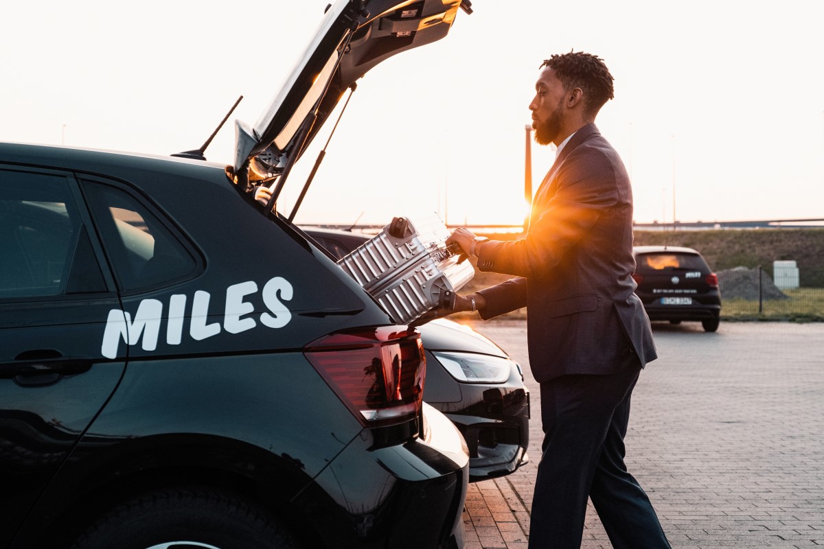  Person loading a vehicle with the print Miles