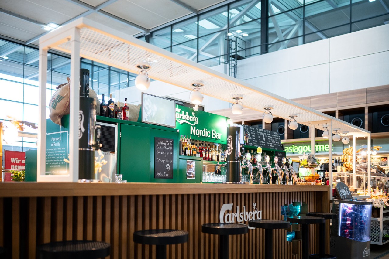 View of the Nordic Bar counter with taps. Terminal 1 in the background.