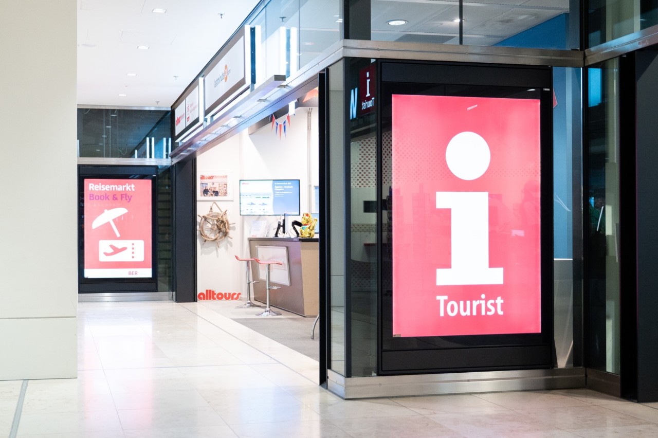 Outside view of the travel market. A poster shows the way.