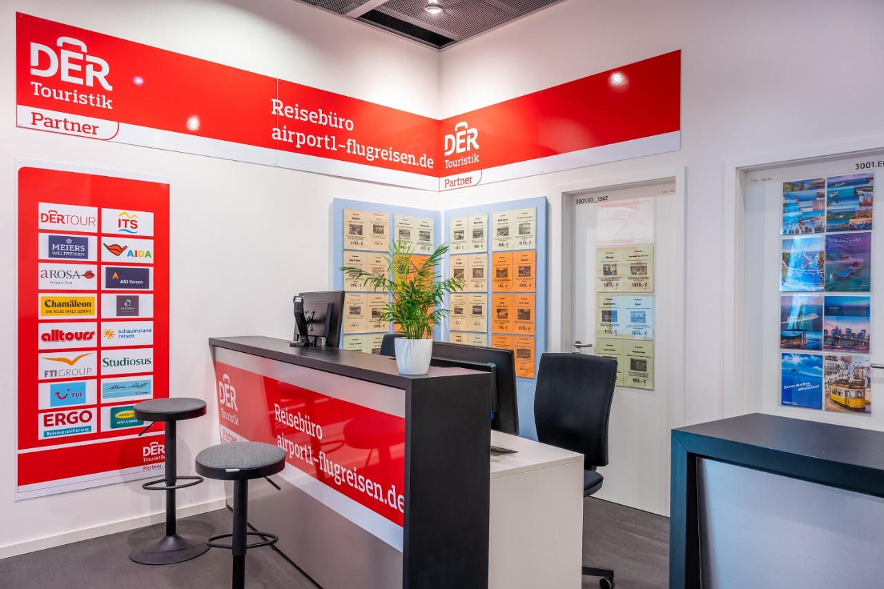  View of the counter of the Airport1 Flugreisen travel agency. Travel offers on the wall.