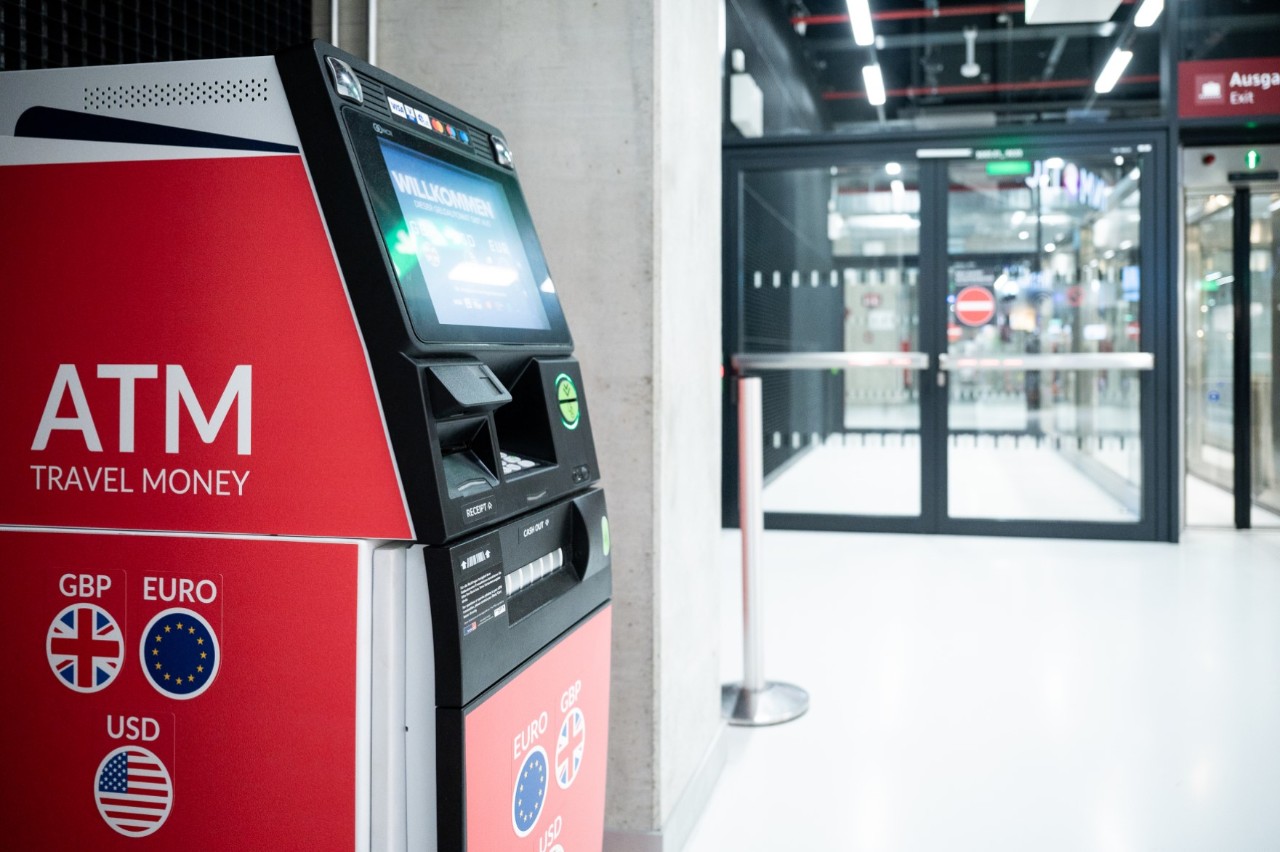 ATM in the foreground. Behind it a glass door.