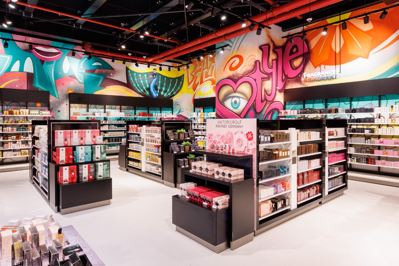 Interior view of the store. Colorful artwork above the shelves.