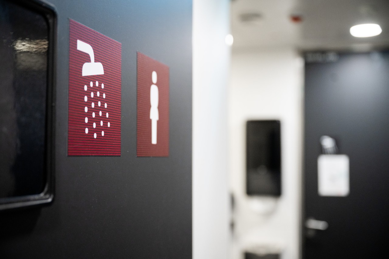 Close-up of a shower pictogram. The background is blurred.