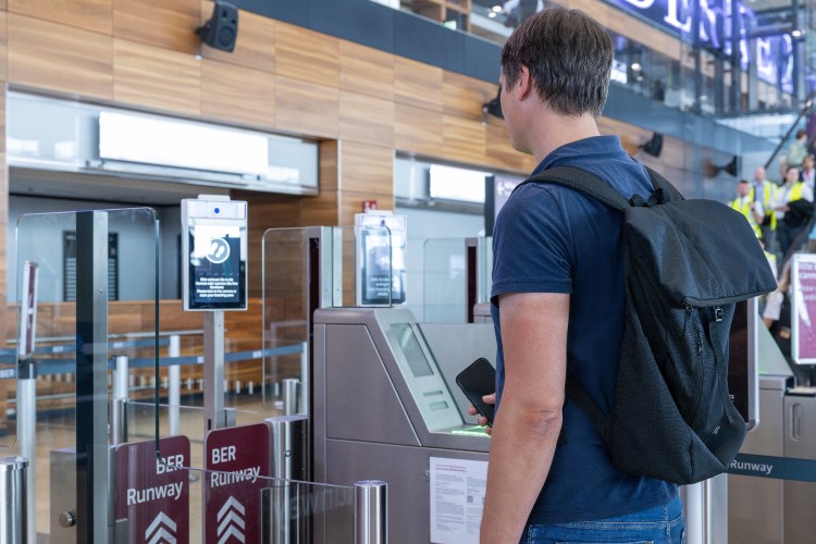 Person standing at BER RUnway and looking into a camera.