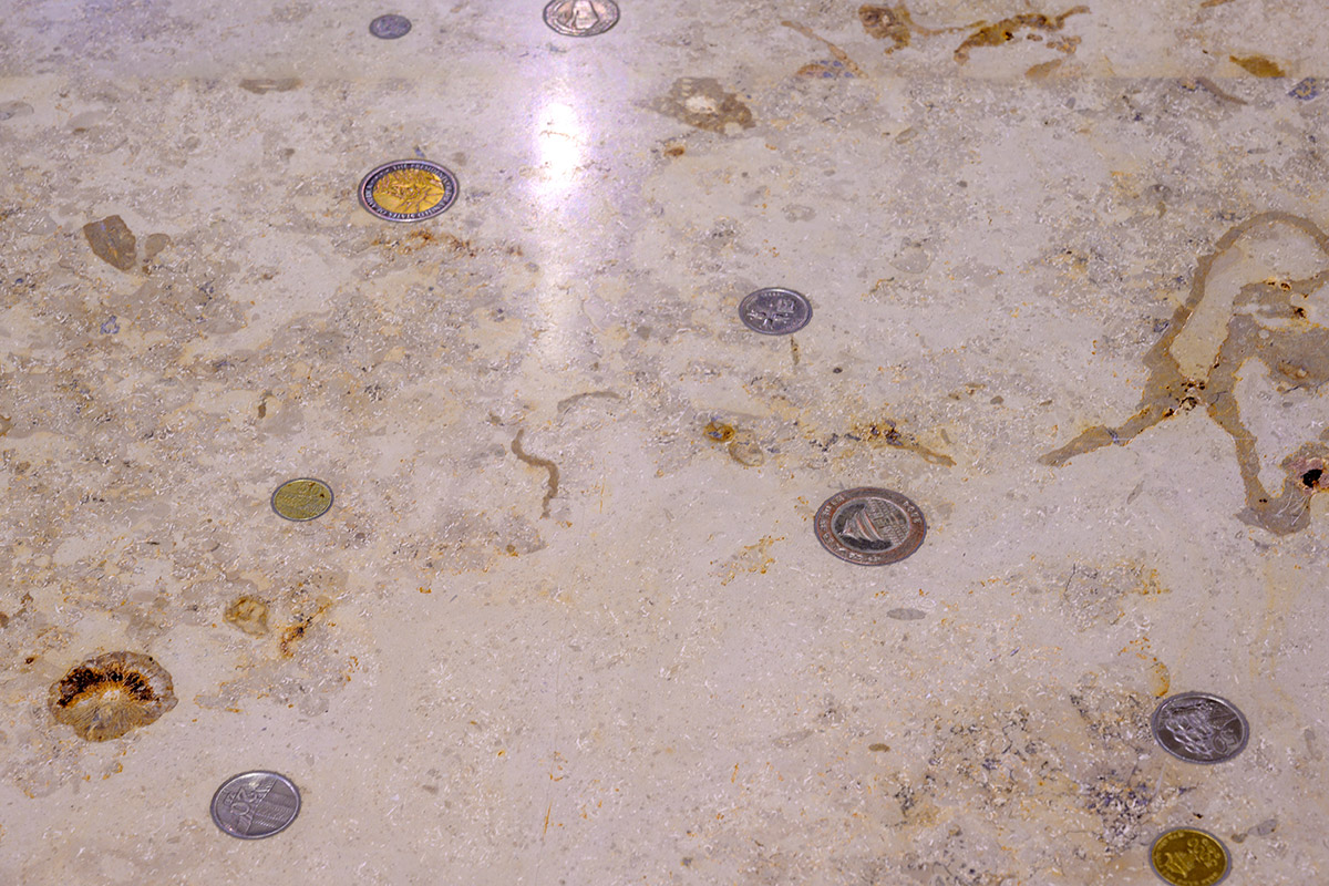 Coins embedded in the ground. The work of art Star Thaler Sky.