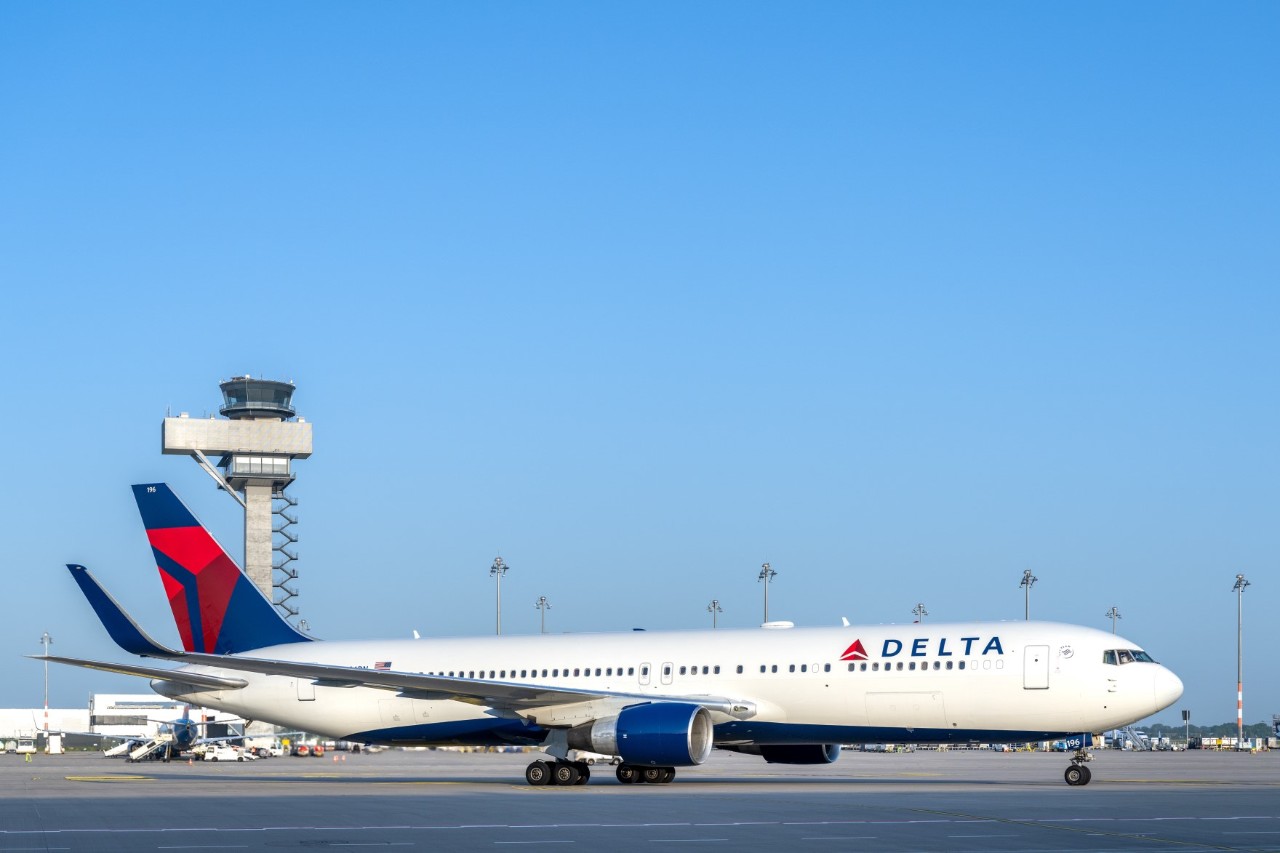 Delta aircraft in front of the BER Tower.