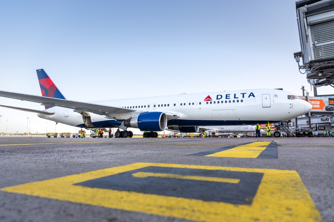 Delta aircraft at a passenger boarding bridge at Terminal 1.