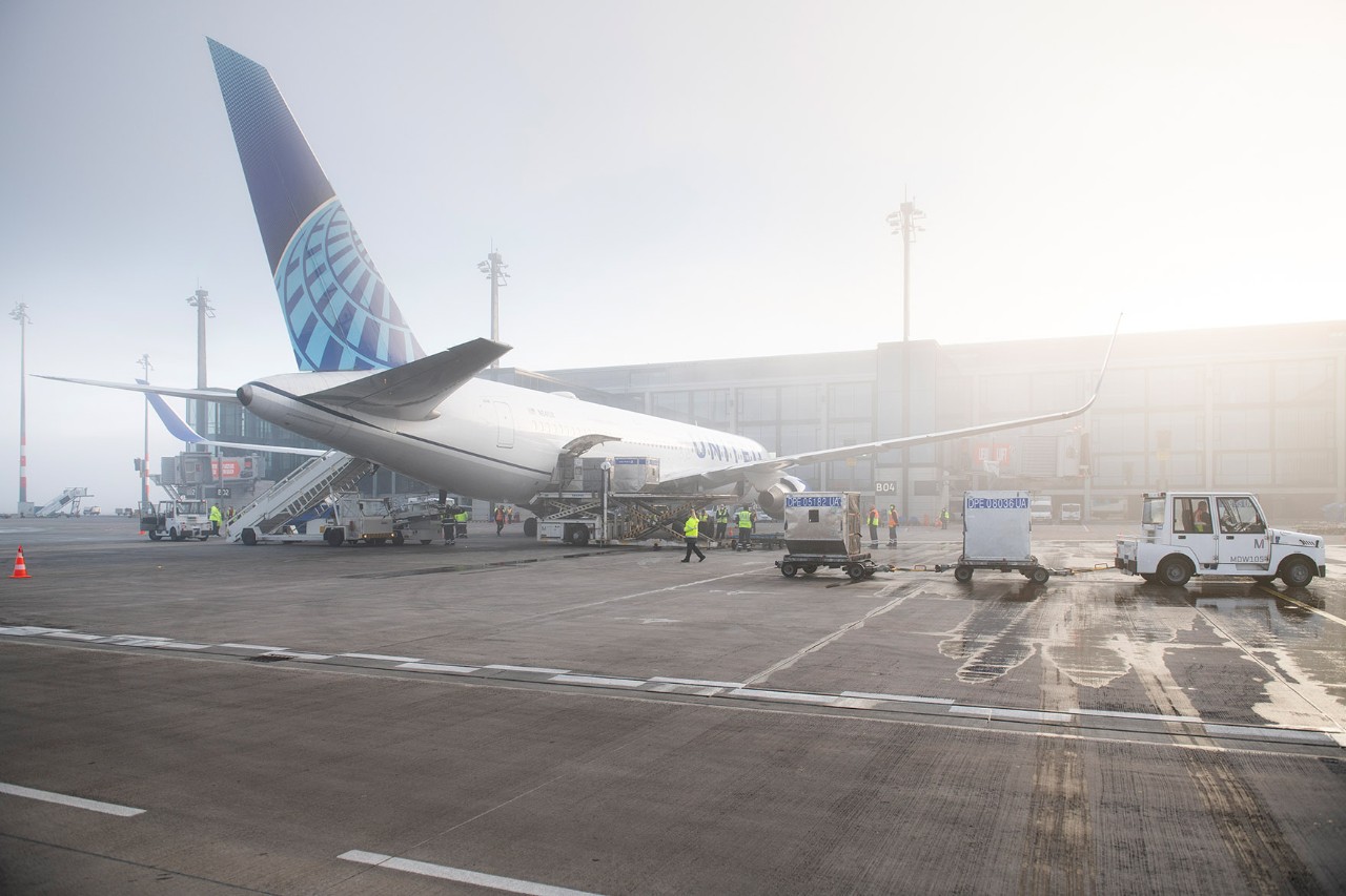 United Airlines stands in front of Terminal 1, the sun is shining.