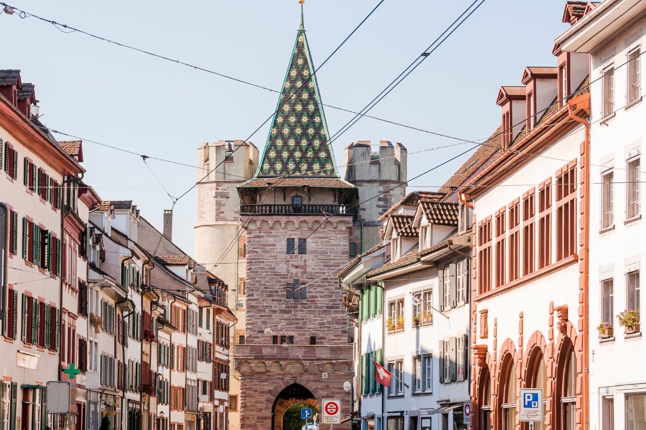Old Town houses packed closely together with a view of the Spalentor gate as part of the city wall 