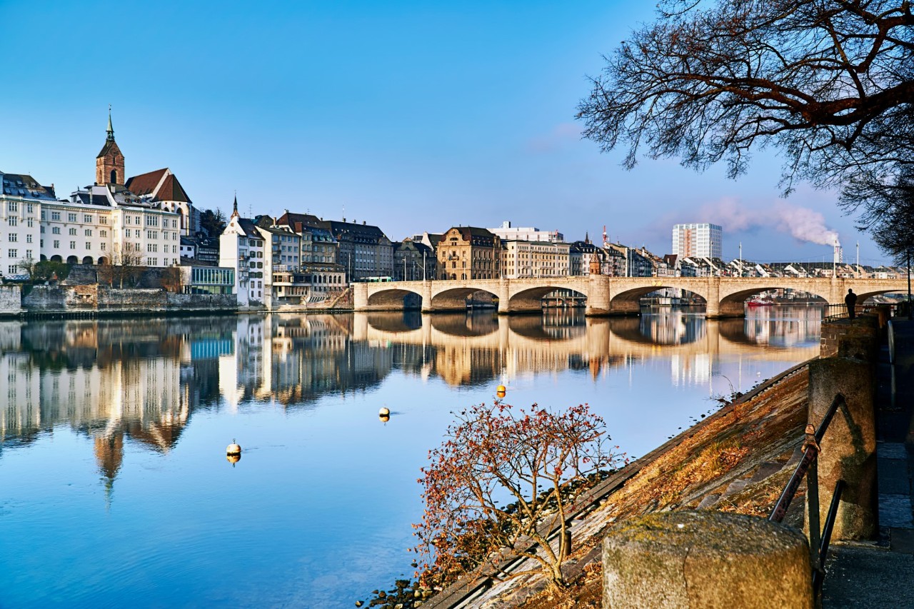 View of the Mittlere Brücke and the banks of the Rhine with buildings on a clear morning