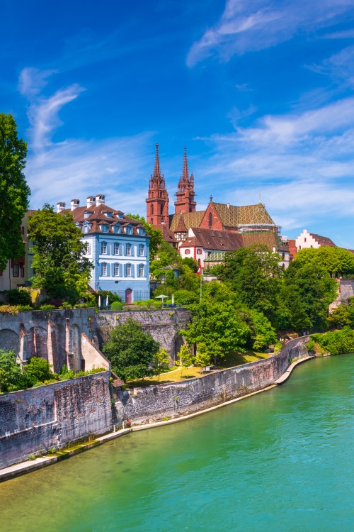 View of the blue-green Rhine River and Basel Old Town with the red minster on the left © gatsi/stock.adobe.com