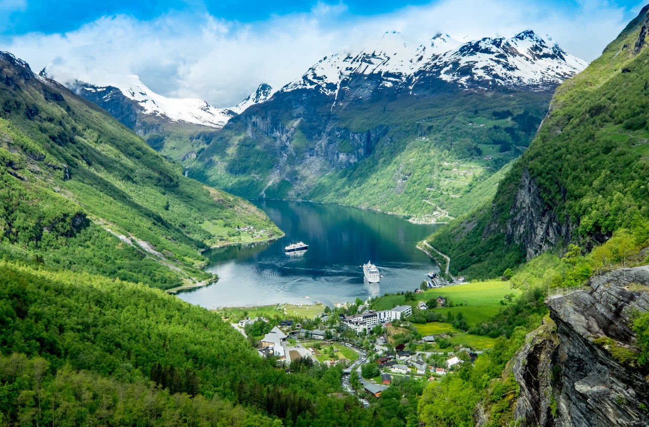 Deep Geirangerfjord with steep cliffs and a waterfall.
